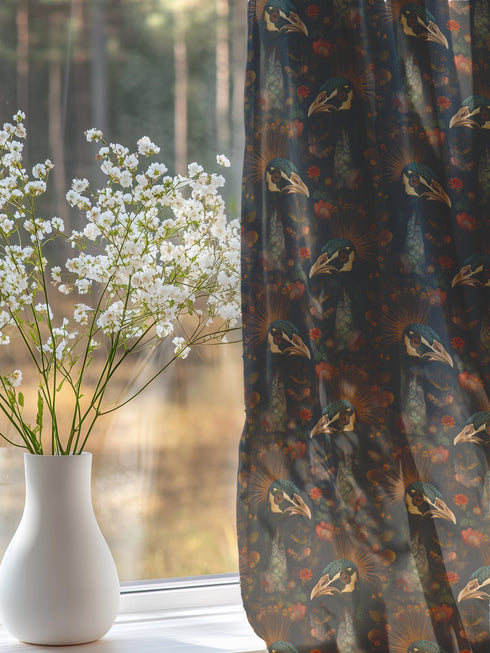 A sheer curtain panel featuring a repeating pattern of amber and forest green peacocks with botanical fan motifs on a dark background, creating a sophisticated Victorian gothic design.